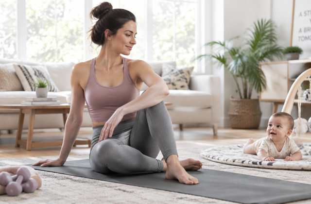 A serene and strong new mother, in her late 20s to early 30s, performing gentle postpartum exercises (e.g., yoga, stretching, light core work) in a bright, airy living room or a sunny park. She has a calm, confident expression. A baby is safely nearby, perhaps in a playpen or on a mat, observing her. The scene emphasizes well-being, safety, and the bond between mother and child. Soft, natural lighting. High-quality, realistic photography style.
